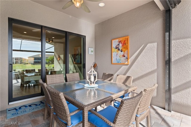 sunroom featuring ceiling fan