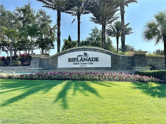 community sign featuring a lawn