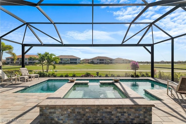 view of swimming pool featuring an in ground hot tub, a lanai, and a patio