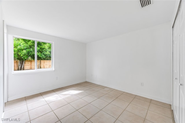 unfurnished room featuring visible vents, baseboards, and light tile patterned flooring