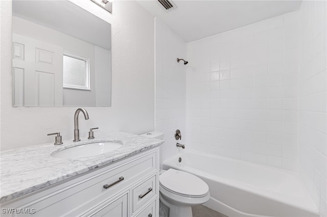 bathroom featuring visible vents, a textured wall, shower / bathing tub combination, toilet, and vanity