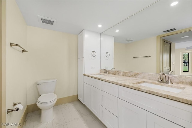 bathroom featuring toilet and vanity