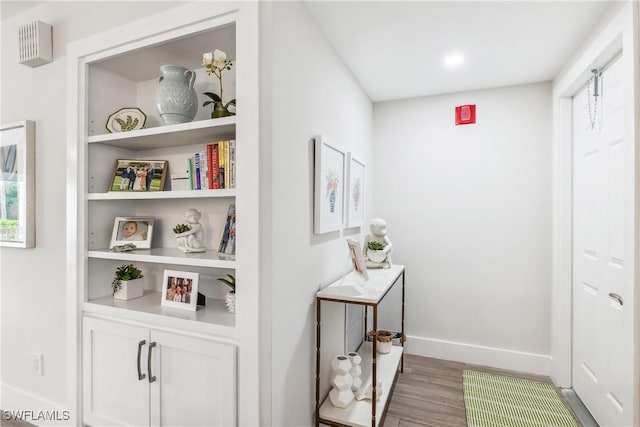 hall with light hardwood / wood-style flooring and built in features