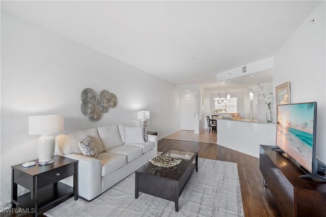 living room featuring hardwood / wood-style flooring and a notable chandelier