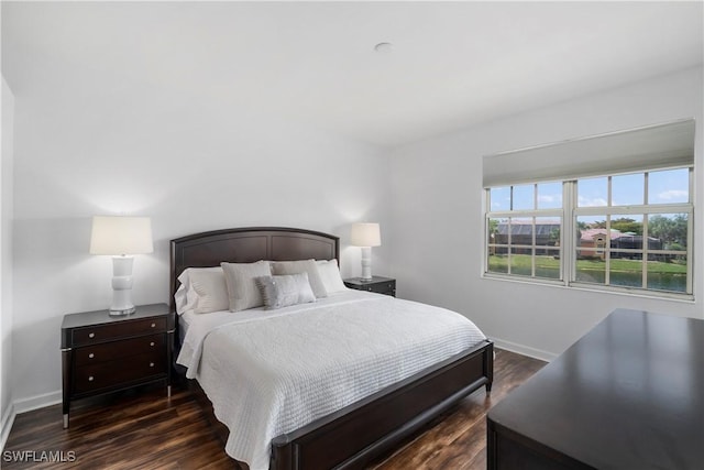 bedroom with dark hardwood / wood-style floors