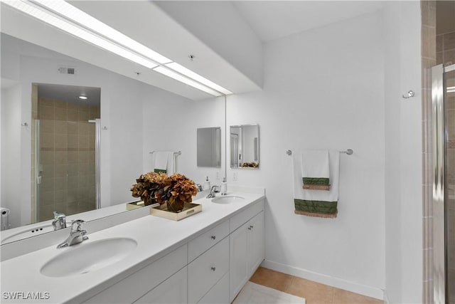 bathroom featuring tile patterned floors, vanity, and an enclosed shower