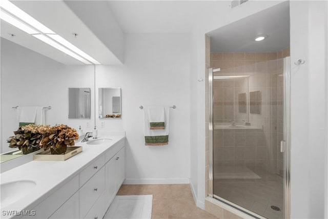 bathroom featuring walk in shower, tile patterned floors, and vanity