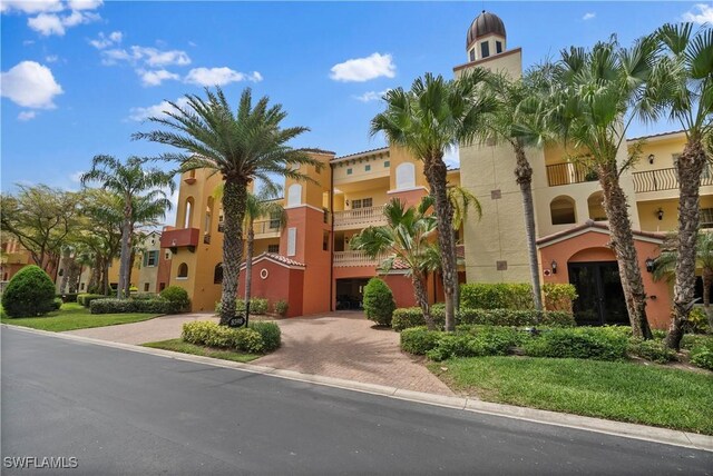 8598 Via Lungomare Cir Unit 203, Estero, FL 33928 - view of building exterior featuring decorative driveway