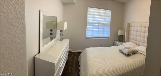 8598 Via Lungomare Cir Unit 203, Estero, FL 33928 - bedroom with dark wood-style floors and baseboards
