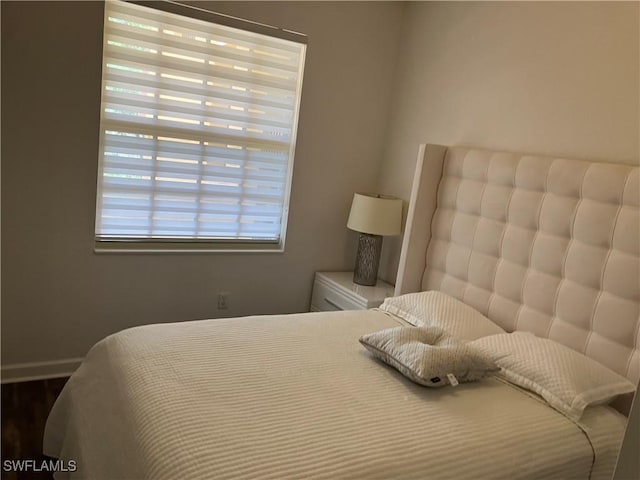 8598 Via Lungomare Cir Unit 203, Estero, FL 33928 - bedroom with baseboards and wood finished floors