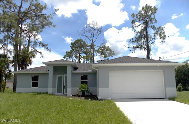 view of front of property with a garage and a front yard