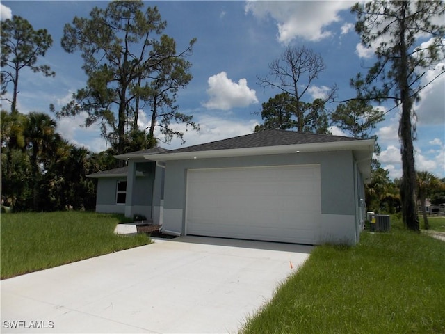 view of front facade with central air condition unit, a garage, and a front lawn