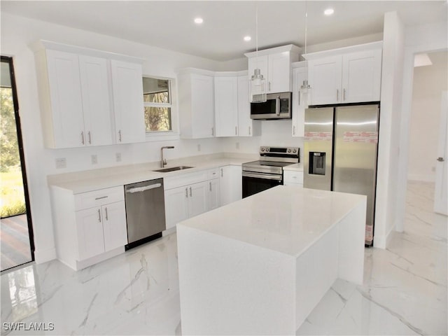 kitchen featuring sink, white cabinetry, a center island, and stainless steel appliances