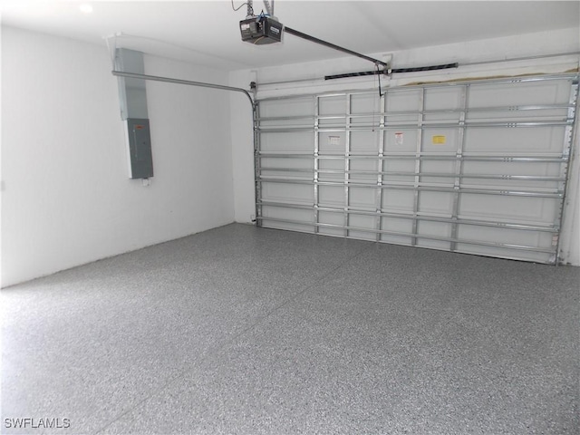 garage with electric panel and a garage door opener