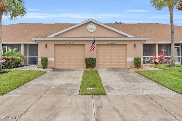 ranch-style home with a garage, a front yard, and a sunroom