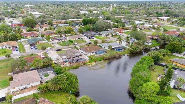 drone / aerial view featuring a water view and a residential view