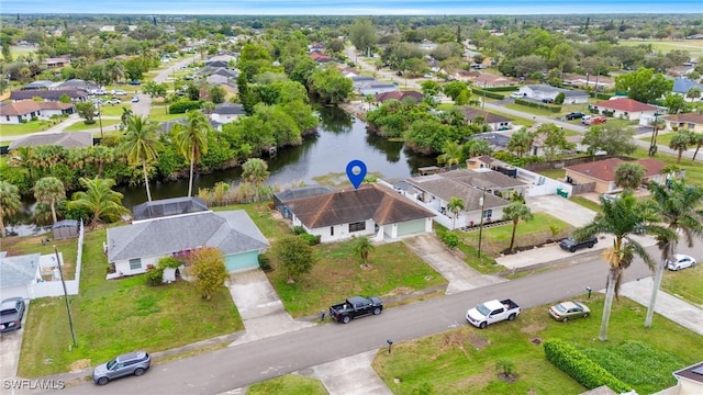 bird's eye view featuring a water view and a residential view