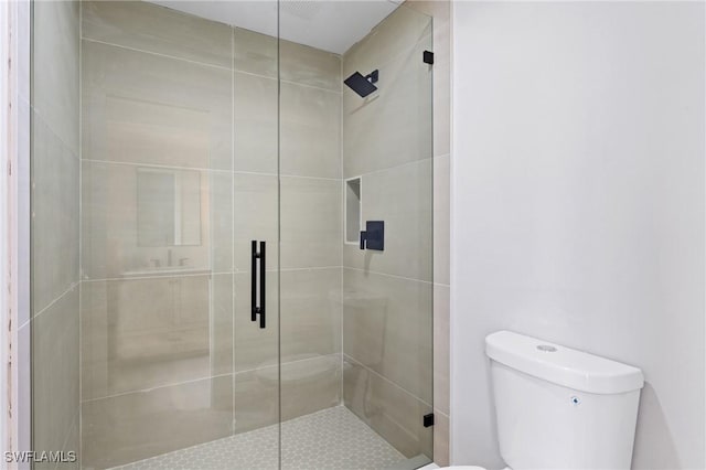 full bathroom with toilet and a stall shower