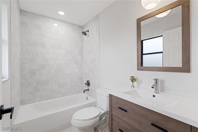 full bathroom with  shower combination, vanity, and toilet