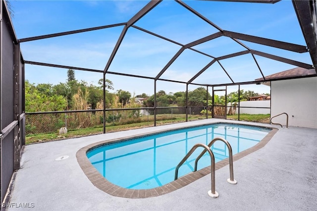 pool with glass enclosure and a patio