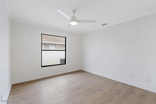 unfurnished room featuring ornamental molding, baseboards, light wood finished floors, and a ceiling fan