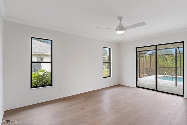 spare room featuring ornamental molding and wood finished floors