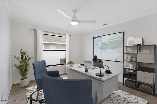 office with visible vents, baseboards, dark wood-style floors, ceiling fan, and crown molding