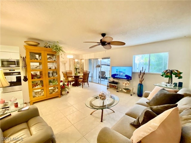 tiled living room featuring ceiling fan