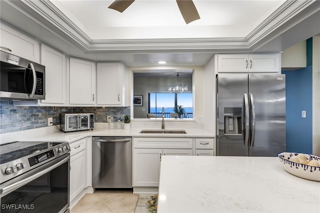 kitchen featuring sink, white cabinets, backsplash, light tile patterned floors, and stainless steel appliances