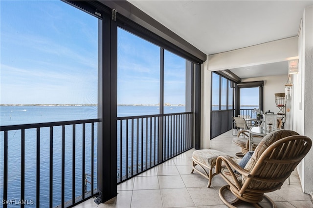 sunroom featuring a water view