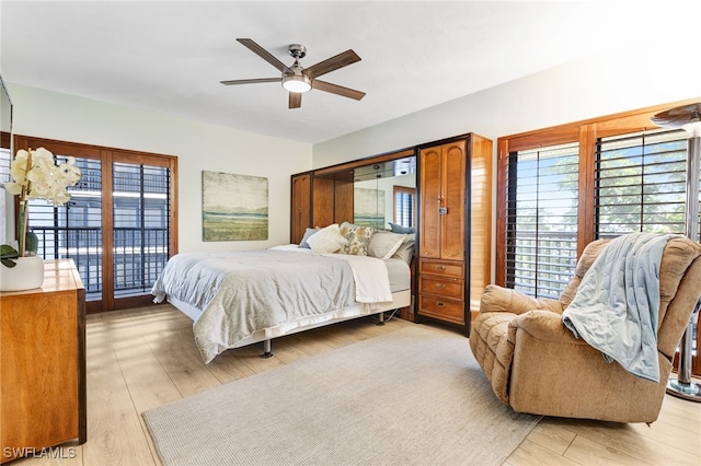 bedroom with access to exterior, light hardwood / wood-style floors, and ceiling fan