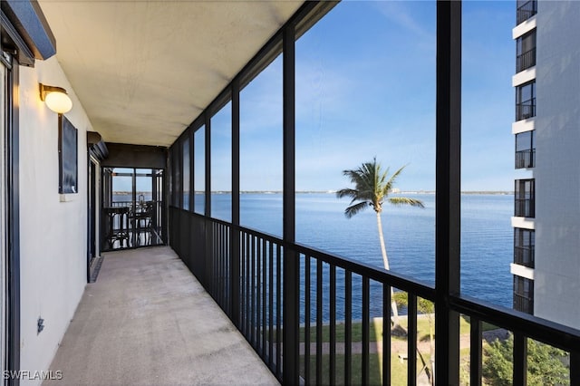 unfurnished sunroom featuring a water view