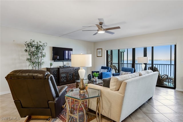 living room featuring light tile patterned floors and ceiling fan