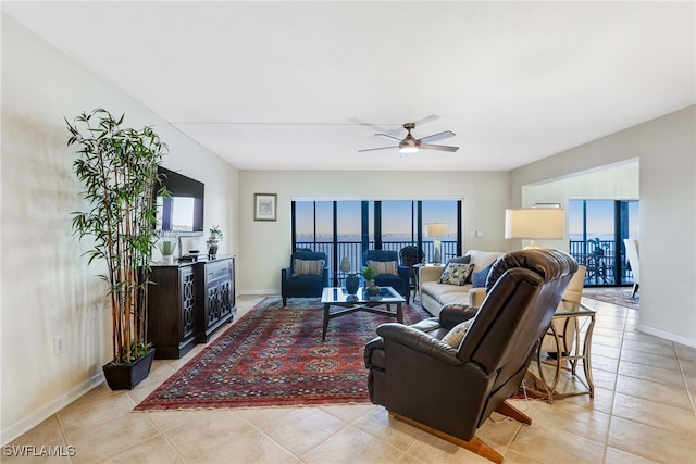 tiled living room featuring a wealth of natural light and ceiling fan