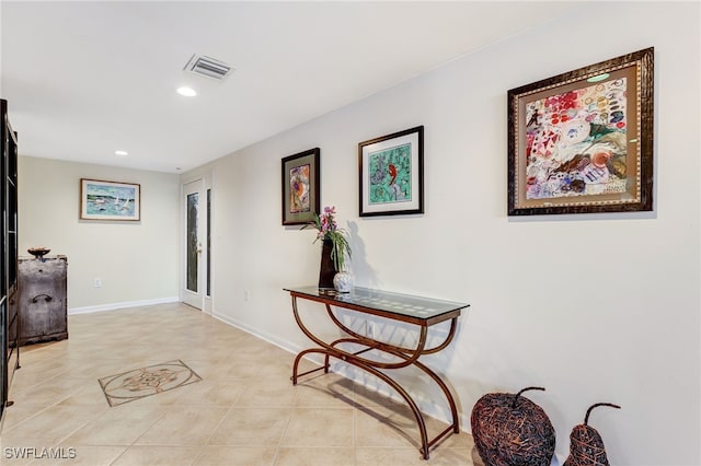 hall featuring light tile patterned floors