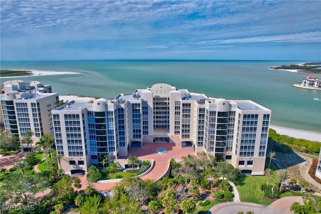 birds eye view of property featuring a water view and a view of the beach