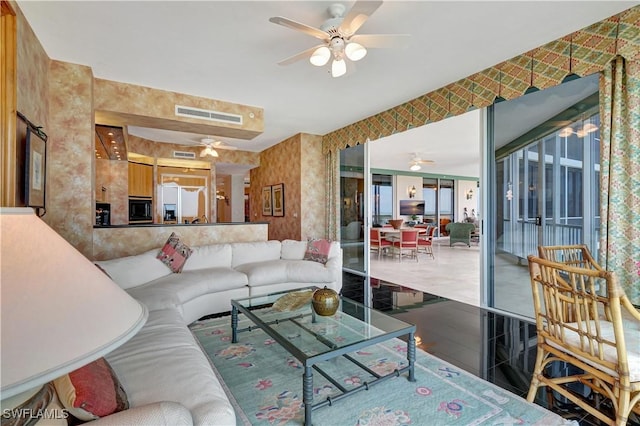 tiled living room featuring ceiling fan