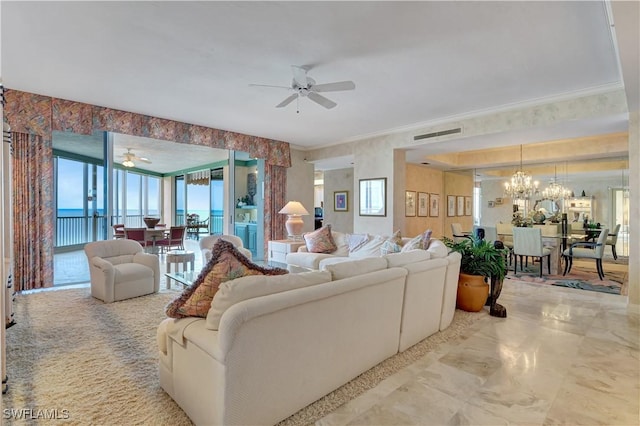 living room featuring a water view, ceiling fan with notable chandelier, and crown molding