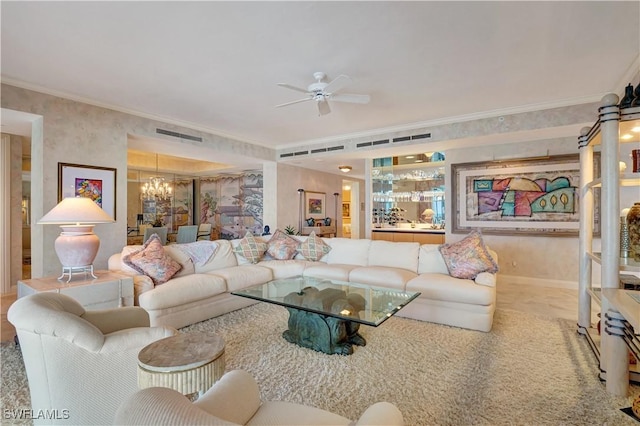 living room featuring ceiling fan with notable chandelier and ornamental molding