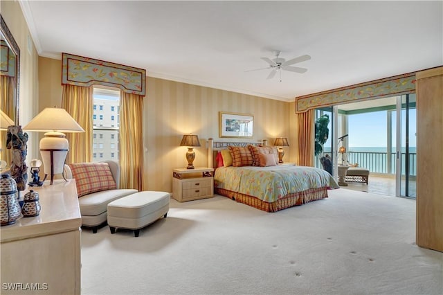 carpeted bedroom with ceiling fan, ornamental molding, access to outside, and a water view