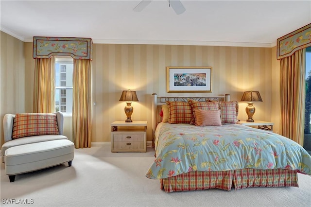 carpeted bedroom featuring crown molding and ceiling fan