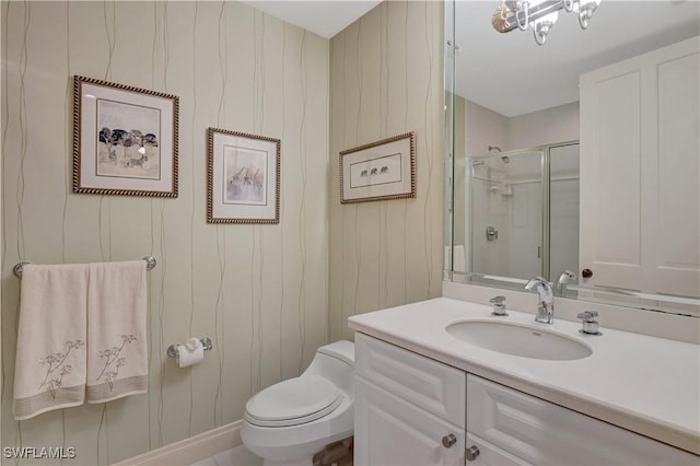 bathroom featuring vanity, toilet, wood walls, and walk in shower