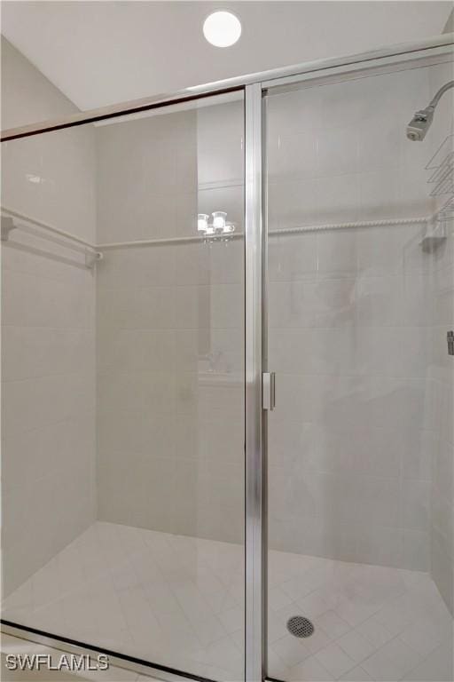 bathroom featuring a shower with shower door