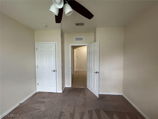 unfurnished bedroom with carpet, visible vents, ceiling fan, and baseboards