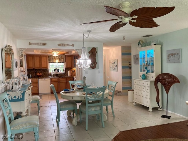 dining room with light tile patterned flooring, ceiling fan with notable chandelier, and a textured ceiling