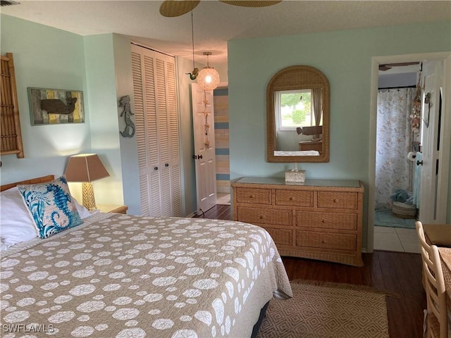 bedroom with dark hardwood / wood-style floors, a closet, and ceiling fan