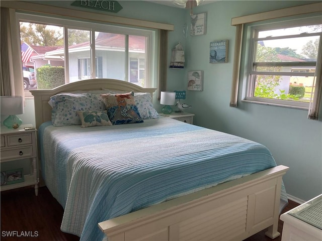 bedroom with dark wood-type flooring