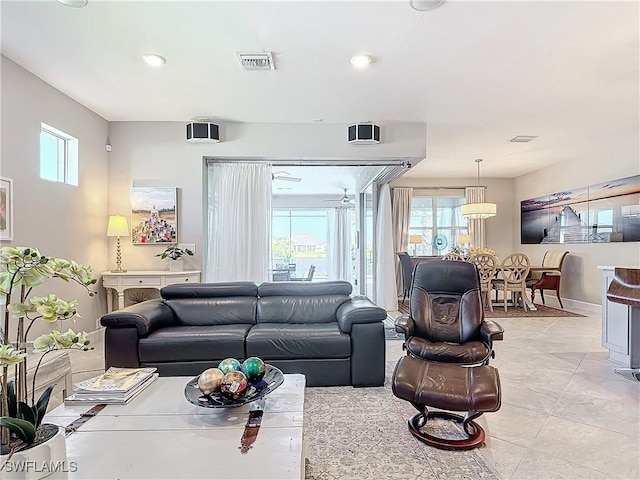 living room featuring light tile patterned flooring and a healthy amount of sunlight