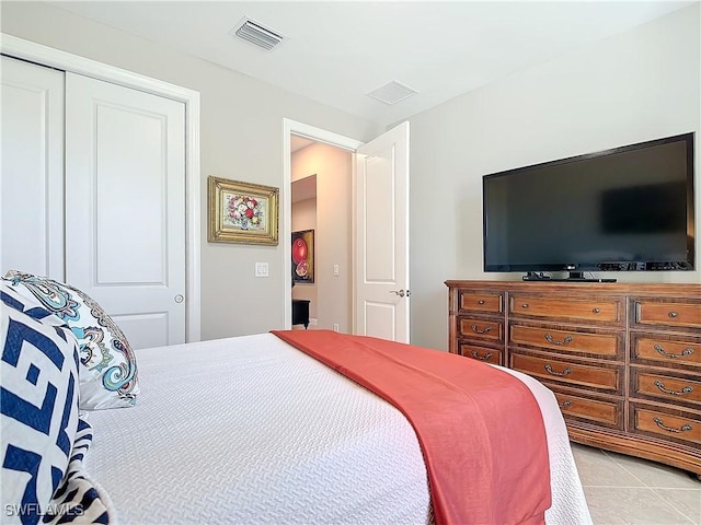 tiled bedroom featuring a closet