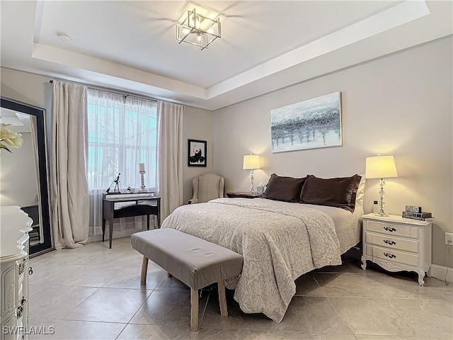 tiled bedroom with a raised ceiling